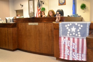 Judge Elliot has an all rise banner in her courtroom to remind us that when rises, we all rise.