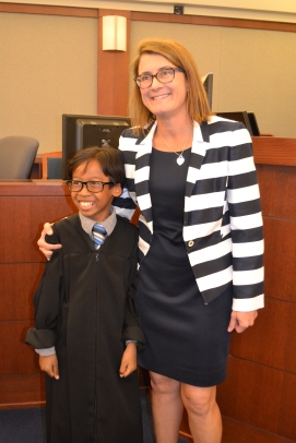 Judge Jennifer Togliatti takes photo with junior judge who nailed his stint on the bench. After his mock role he said he wants to be a judge.
