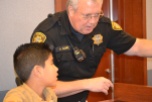 Marshal Bill Campbell teaches a young recruit the ropes of keeping a courtroom safe.